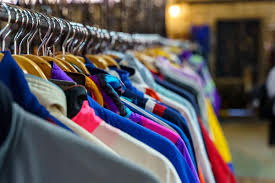 Woman holding clothes in a fashion store